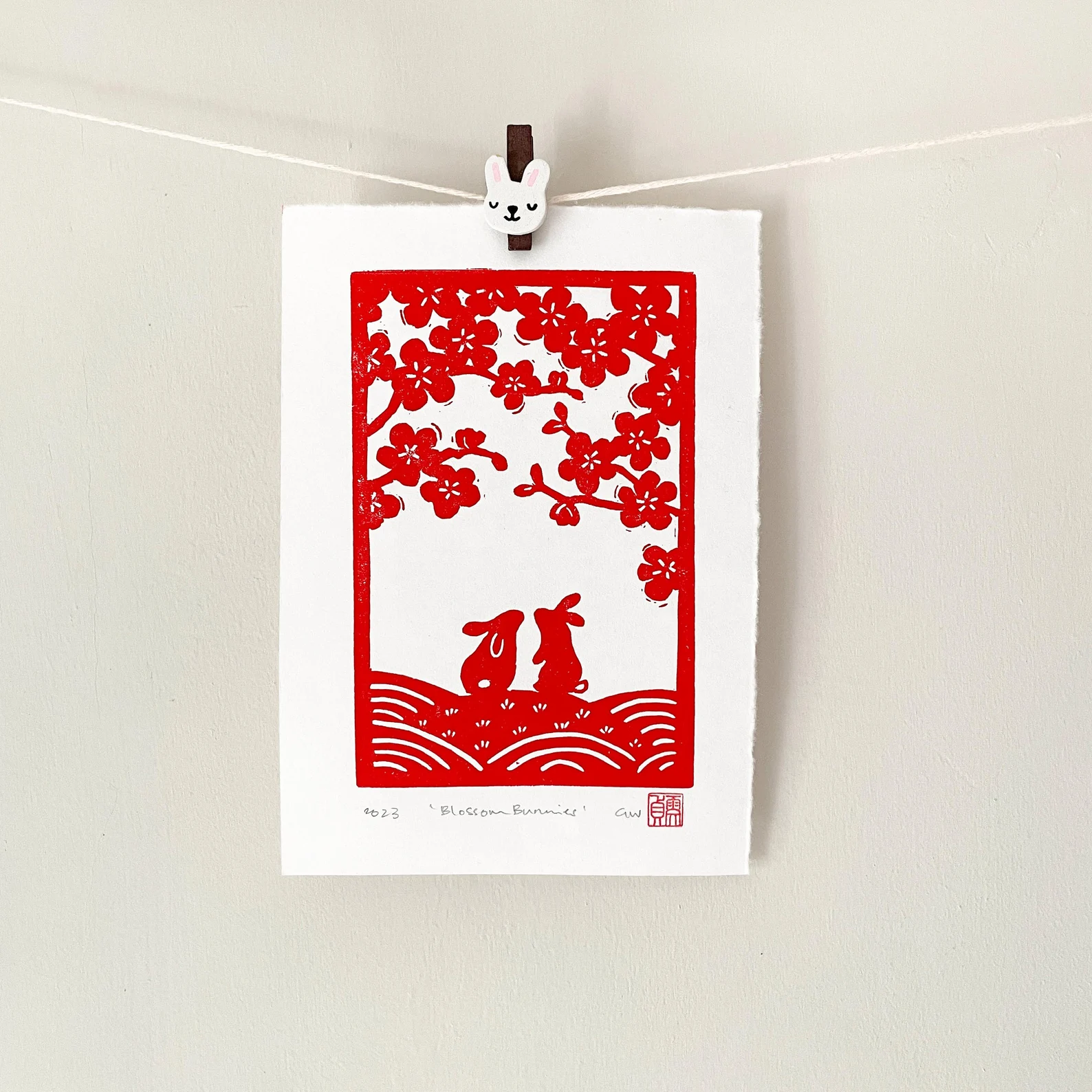 Blossom bunnies linocut print – rabbit wall art by Grace Wong